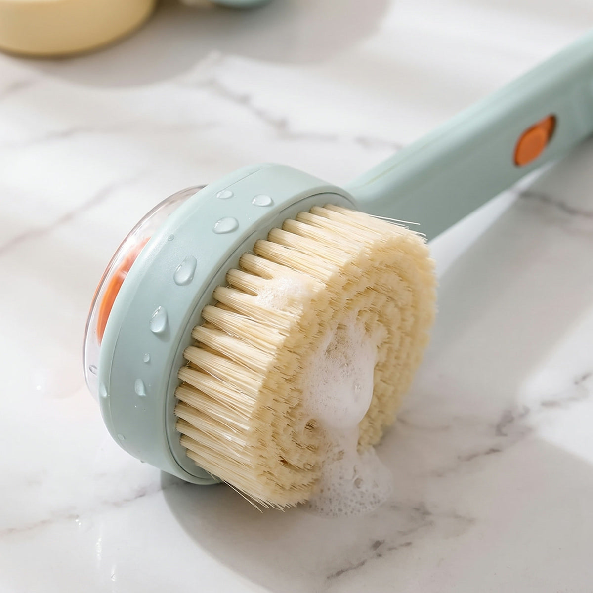 Close-up of the soft dense bristles and the clear soap reservoir window on the back of the Lather Reach brush head