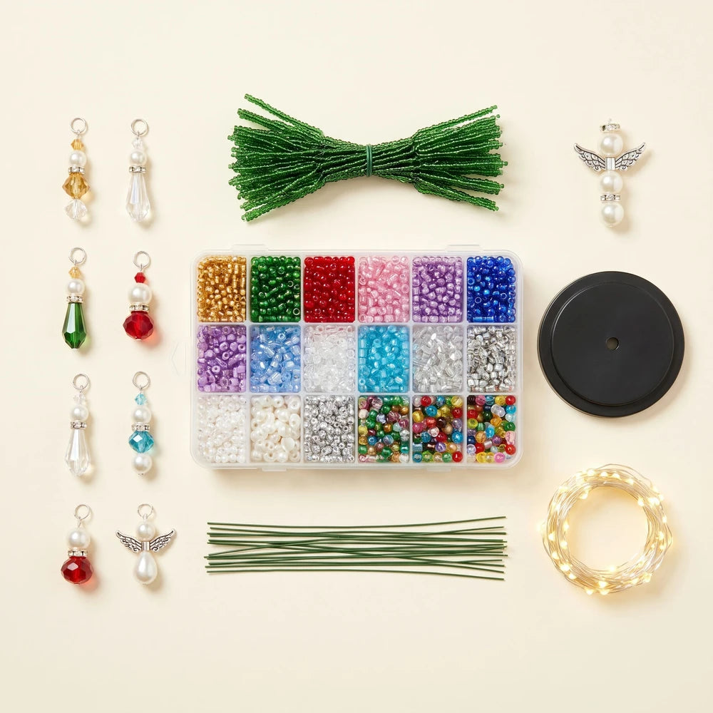 Everything included in the beaded Christmas tree kit: beaded branches, glass beads, ornament charms, angel topper, display base and LED fairy lights