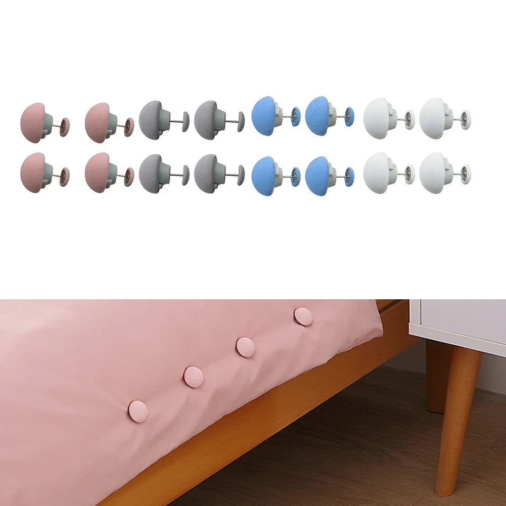 Stay-Put Duvet Clips in pink grey blue and white shown in pairs with clips fastened along a bed