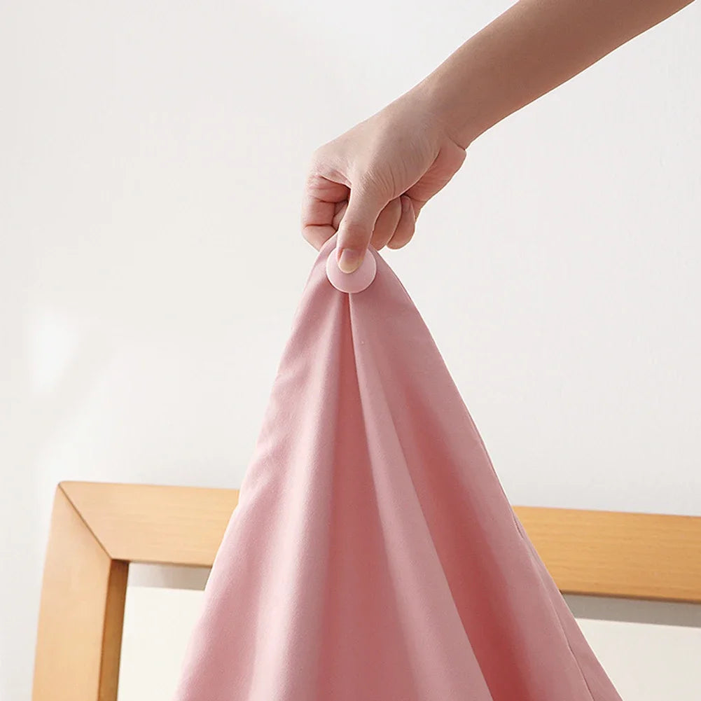 Hand lifting an entire duvet by one Stay-Put clip to show its locked grip strength