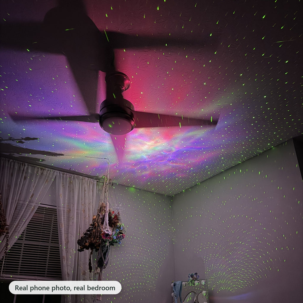 Real phone photo of the astronaut projector's nebula and green stars on a bedroom ceiling around a ceiling fan