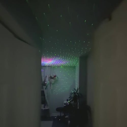 Astronaut Galaxy Star Projector in action: a bedroom door opens on a ceiling full of nebula and green stars, and the colors change across the ceiling