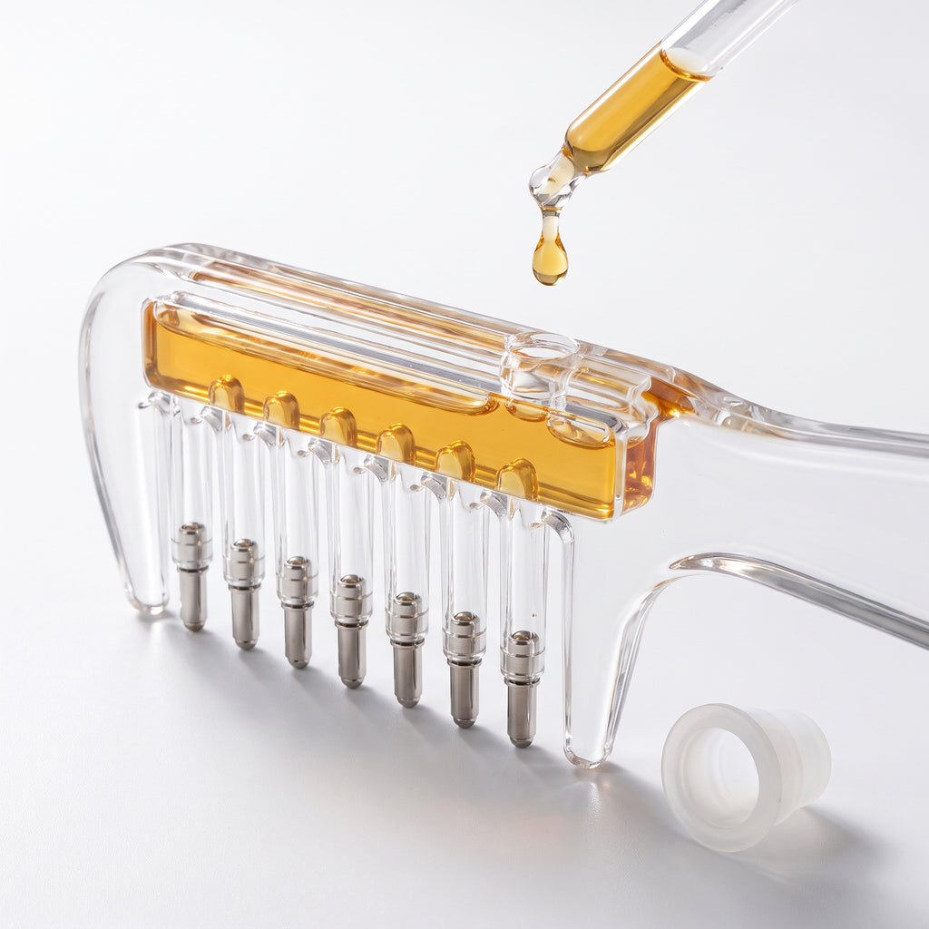 Serum dropping from a dropper into the Scalp Serum Applicator Comb reservoir