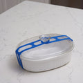 Stretch Lid Strap in blue wrapped around a white casserole dish and hooked over the glass lid knob