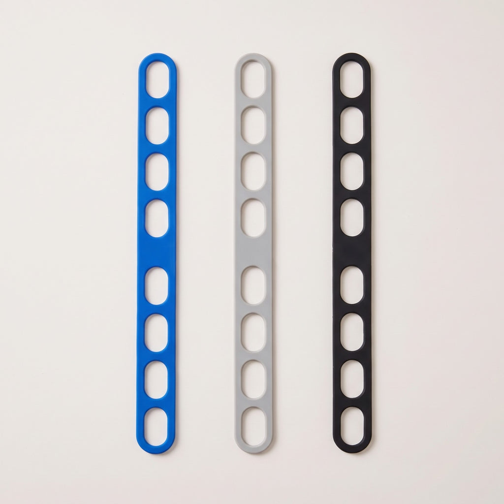 The lid strap in its three colors side by side: blue, grey and black