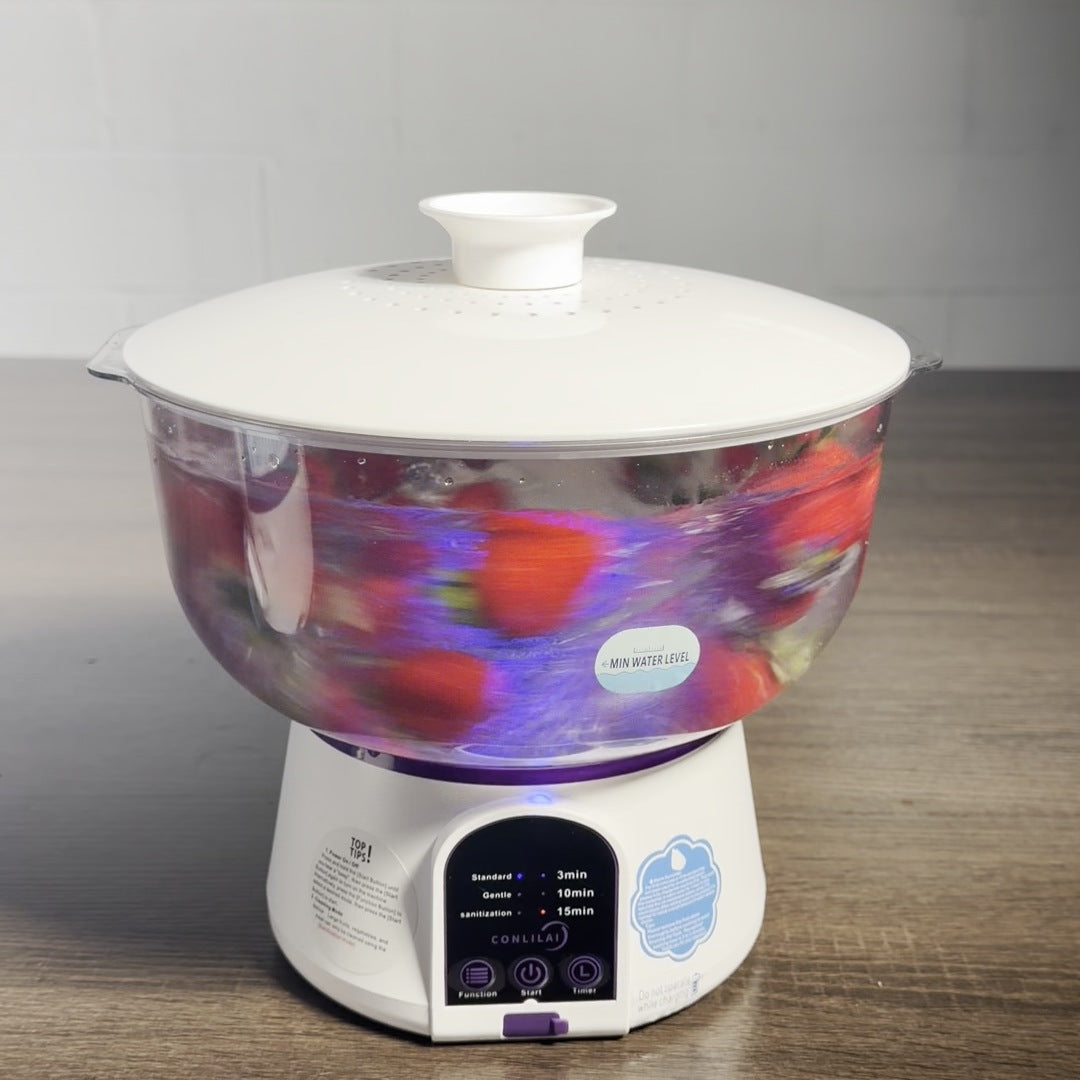Vortex Produce Washer running with strawberries, lid on, the light under the bowl glowing