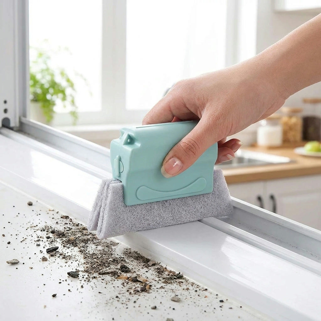 Teal window track cleaner brush gliding along a white window track pulling out dark gunk